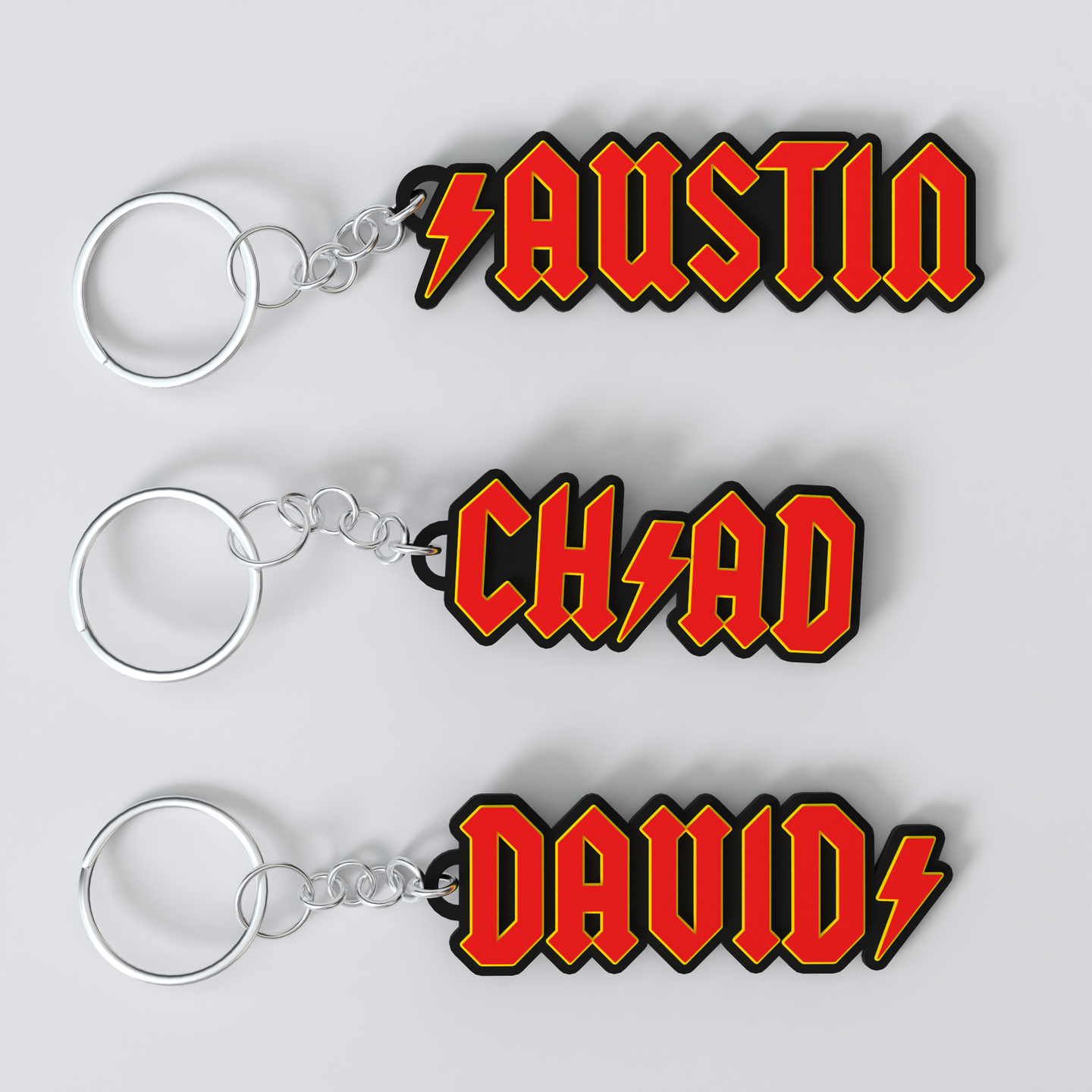 Custom ACDC keychains with the names 'Austin', 'Chad', and 'David'.
