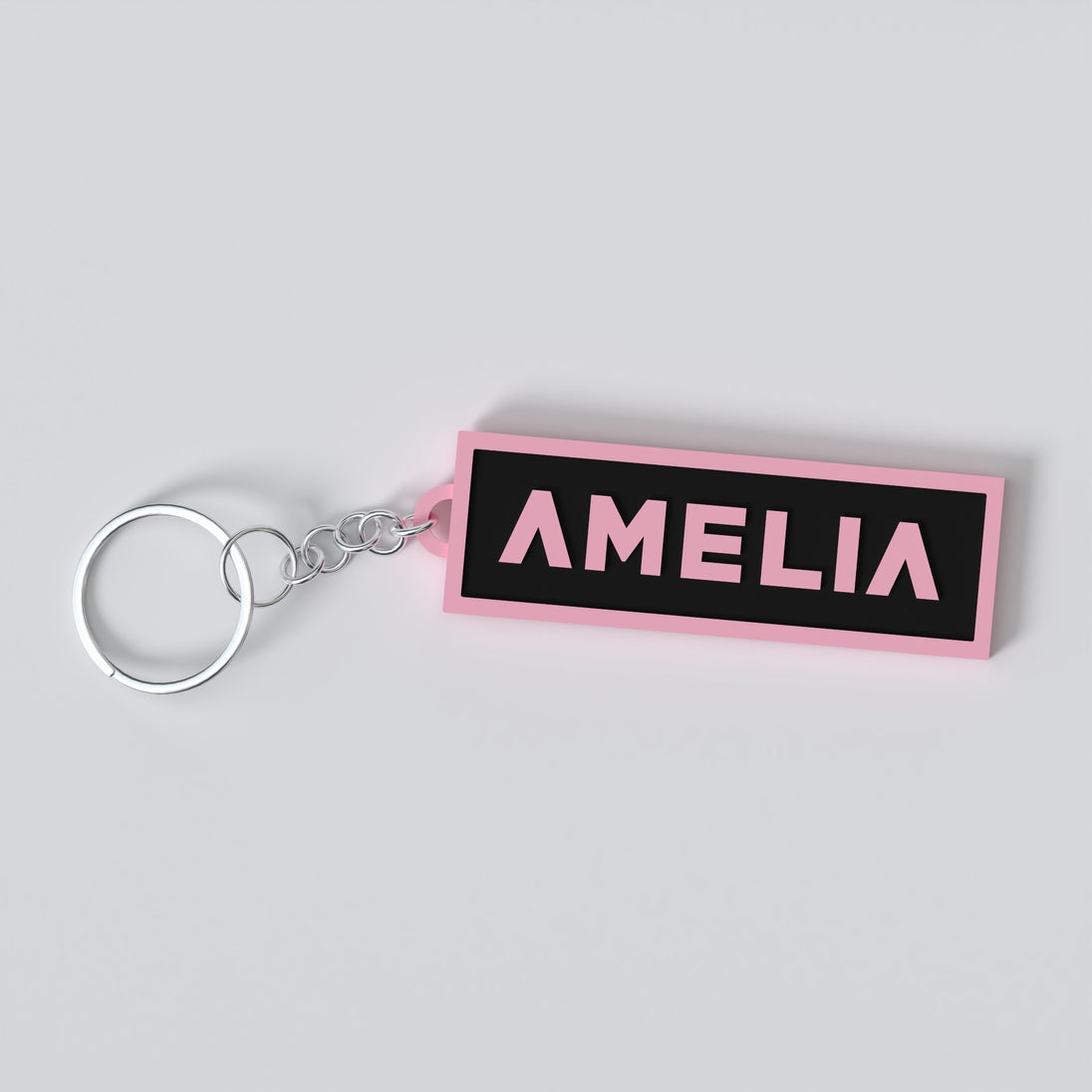 Black pink custom keychains with the names "AMELIA"