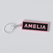 Black pink custom keychains with the names "AMELIA"