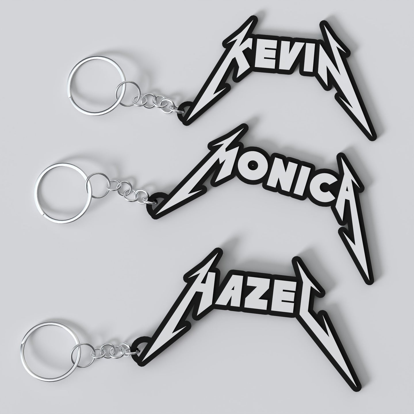 Custom Metallica keychains with personalized names, featuring a stylized metal band logo design in black and metallic finish.