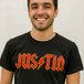 Man wearing a black ACDC band custom t-shirt with 'JUSTIN' printed in red and yellow.