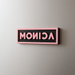 Blackpink custom magnet with the name 'MONICA' in pink letters on a gray fridge.