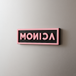 Blackpink custom magnet with the name 'MONICA' in pink letters on a gray fridge.