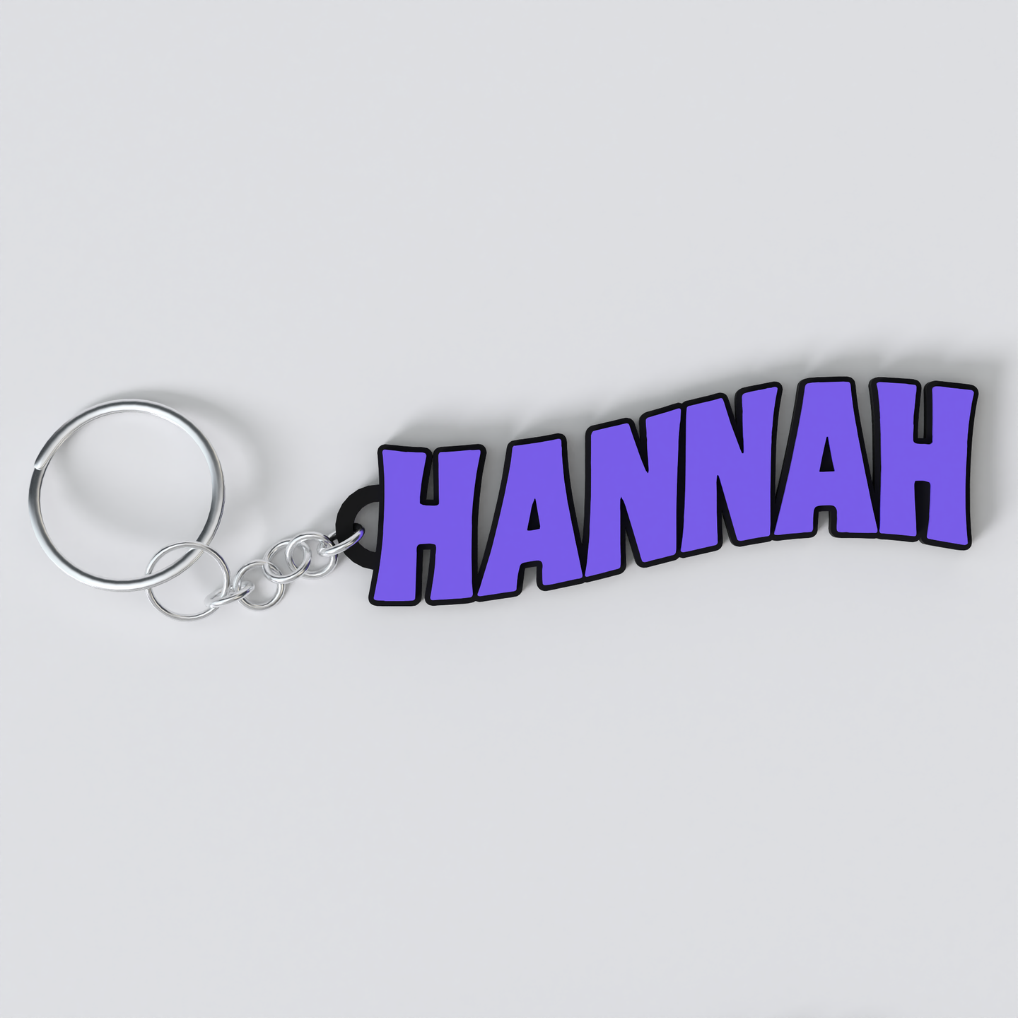 A custom Black Sabbath keychain with the name HANNAH printed in purple on a white background.