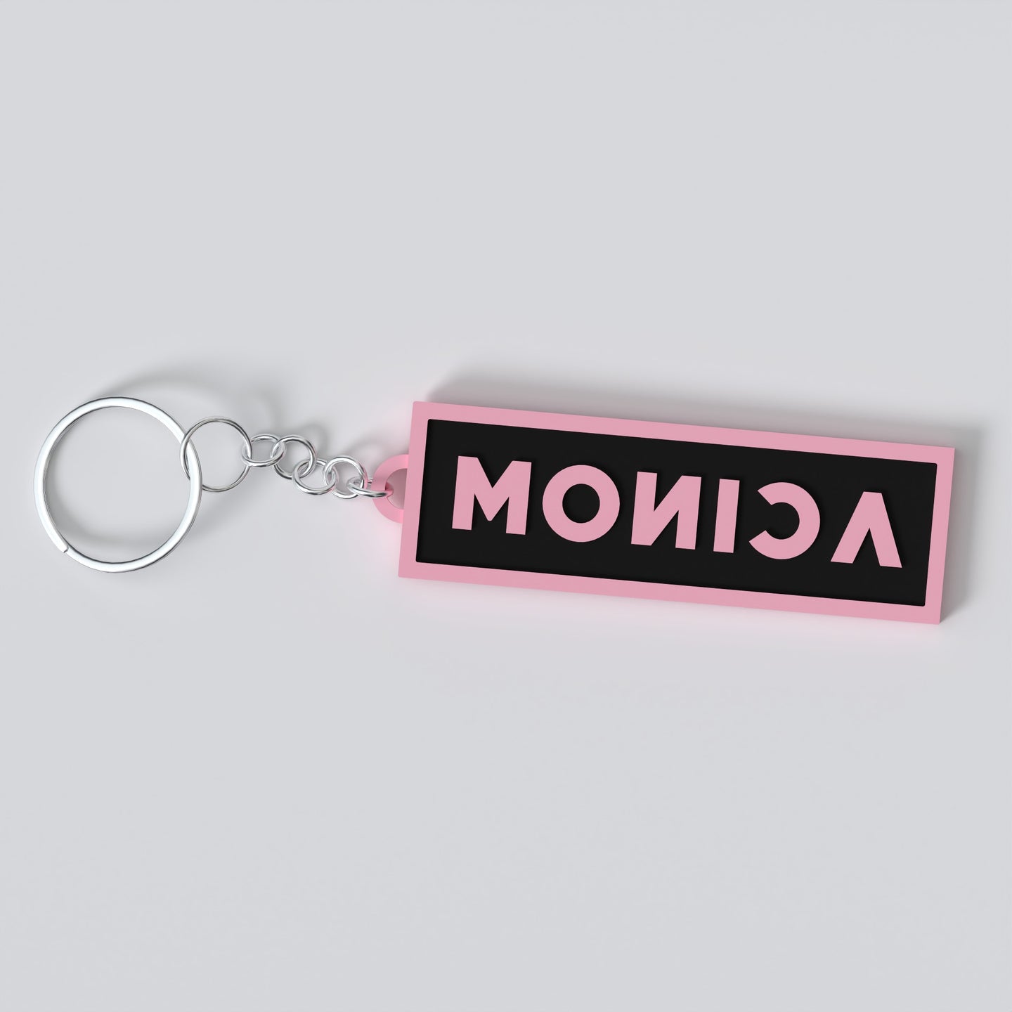 Black pink custom keychains with the names "MONICA"