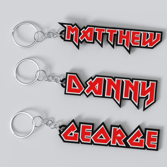 Custom Iron Maiden keychains with different names printed in a stylized font resembling a metal band logo.
