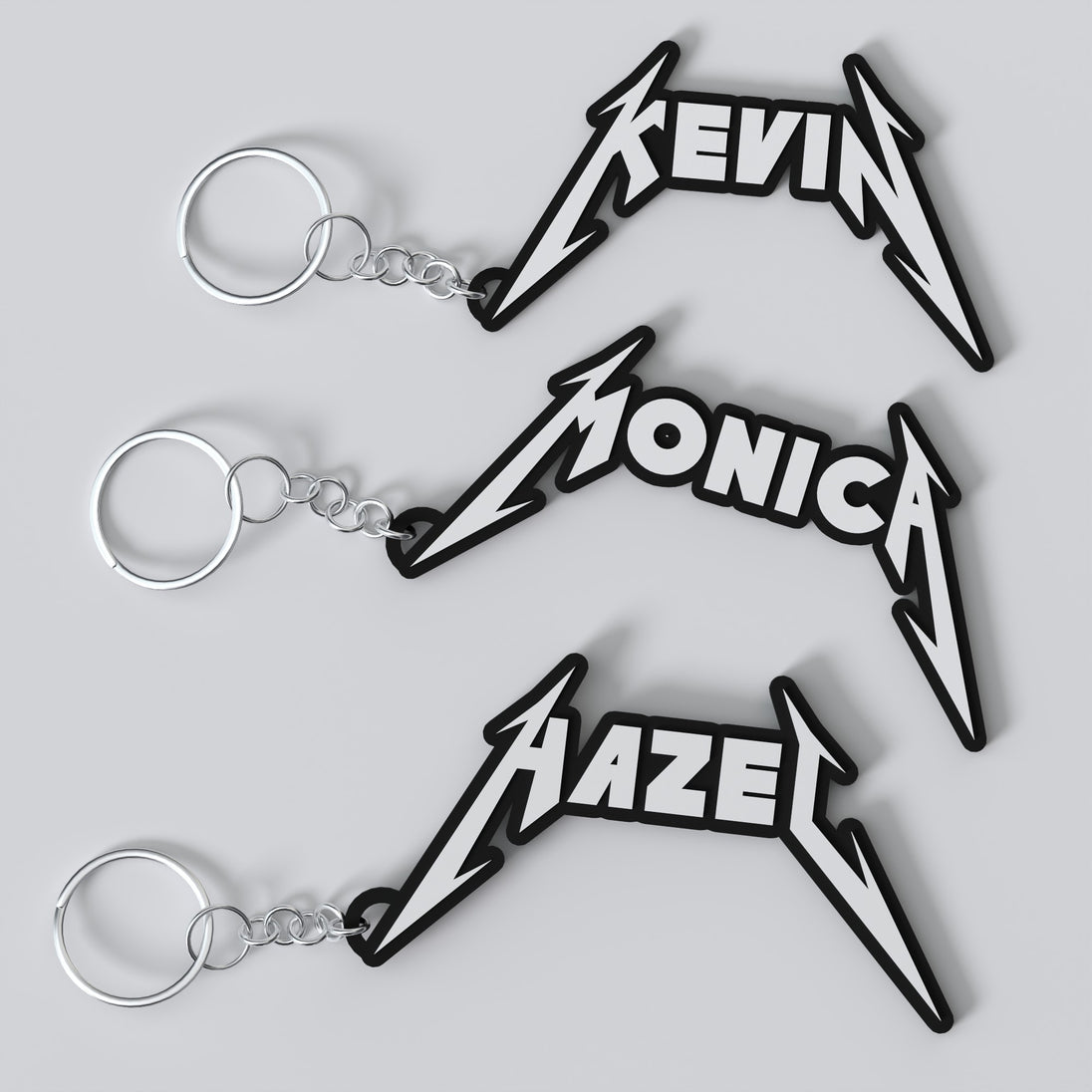 Custom Metallica keychains with personalized names, featuring a stylized metal band logo design in black and metallic finish.